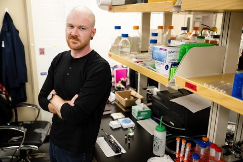 Dane Santa stands in a chemistry lab